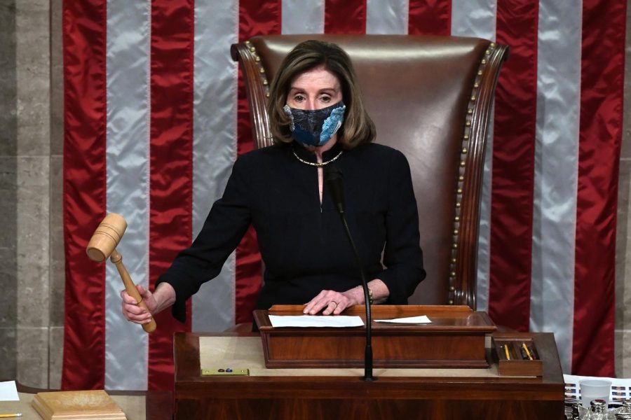 Speaker of the House Nancy Pelosi puts down the gravel as she presides the US House of Representatives vote on the impeachment of US President Donald Trump at the US Capitol, January 13, 2021, in Washington, DC. - The Democrat-controlled US House of Representatives on January 13 opened debate on a historic second impeachment of President Donald Trump over his supporters' attack of the Capitol that left five dead. (Photo by SAUL LOEB / AFP) (Photo by SAUL LOEB/AFP via Getty Images)