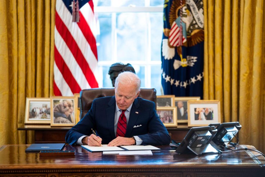 WASHINGTON, DC - JANUARY 28: U.S. President Joe Biden signs executive actions in the Oval Office of the White House on January 28, 2021 in Washington, DC. President Biden signed a series of executive actions Thursday afternoon aimed at expanding access to health care, including re-opening enrollment for health care offered through the federal marketplace created under the Affordable Care Act. (Photo by Doug Mills-Pool/Getty Images)