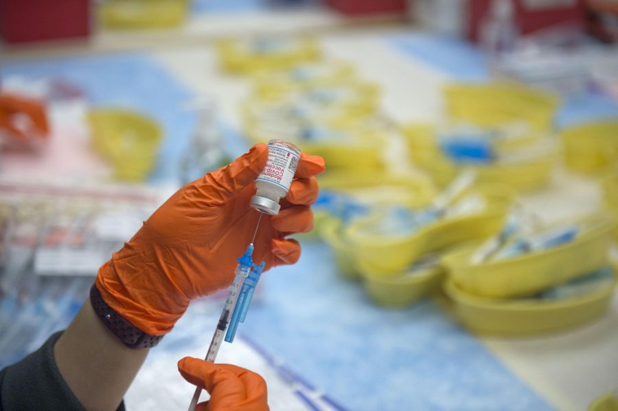 A healthcare worker prepares a dose of the Moderna Covid-19 vaccination at a drive-thru clinic at the Richard M. Borchard Regional Fairgrounds in Robstown, Texas, U.S., on Tuesday, Jan. 26, 2021. Hundreds of thousands of Texans will likely get their first doses of the vaccine starting the week of January 25. Photographer: Eddie Seal/Bloomberg via Getty Images