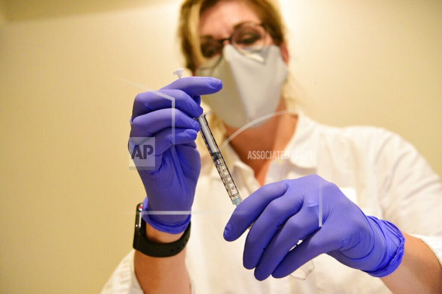 This Sept. 2020 photo provided by Johnson &amp; Johnson shows a clinician preparing to administer investigational Janssen COVID-19 vaccine. Johnson &amp; Johnson's long-awaited COVID-19 vaccine appears to protect against symptomatic illness with just one shot – not as strong as some two-shot rivals but still potentially helpful for a world in dire need of more doses. Johnson &amp; Johnson said Friday, Jan. 29, 2021 that in the U.S. and seven other countries, the first single-shot vaccine appears 66% effective overall at preventing moderate to severe COVID-19. It was more protective against severe symptoms, 85%. (Johnson &amp; Johnson via AP)