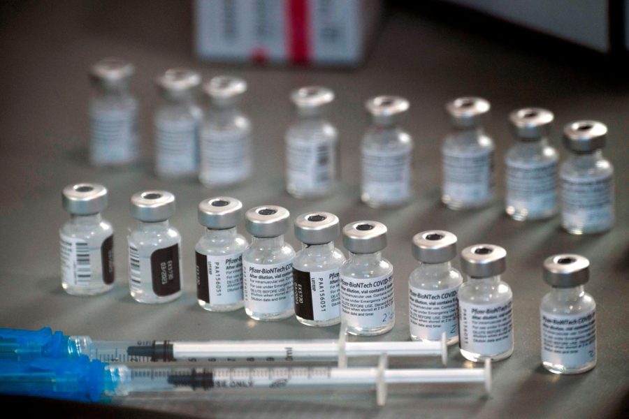 Syringes wand vials of the Pfizer-BioNTech Covid-19 vaccine are prepared to be administered to front-line health care workers under an emergency use authorization at a drive up vaccination site from Renown Health in Reno, Nevada on December 17, 2020. (Photo by Patrick T. Fallon / AFP) (Photo by PATRICK T. FALLON/AFP via Getty Images)