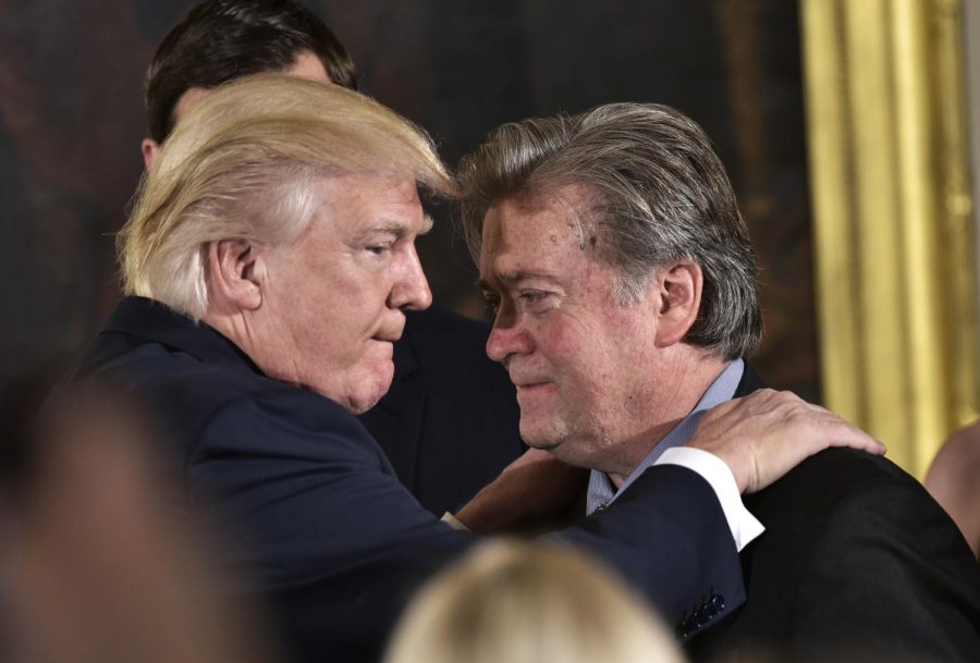 US President Donald Trump (L) congratulates Senior Counselor to the President Stephen Bannon during the swearing-in of senior staff in the East Room of the White House on January 22, 2017 in Washington, DC. 