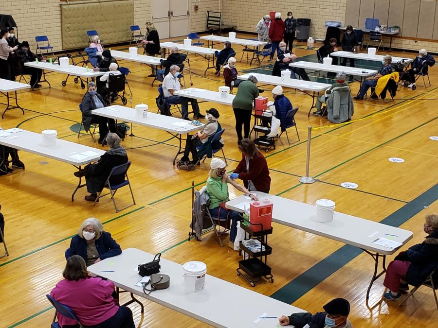 Members of the community near the Kent State Ashtabula campus receive their COVID-19 vaccines in the campus gymnasium. 