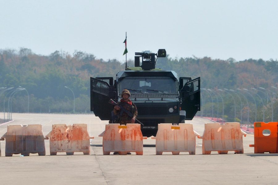 A soldier stands guard on a blockaded road to Myanmar's parliament in Naypyidaw on February 1, 2021, after the military detained the country's de facto leader Aung San Suu Kyi and the country's president in a coup. (Photo by STR / AFP) (Photo by STR/AFP via Getty Images)