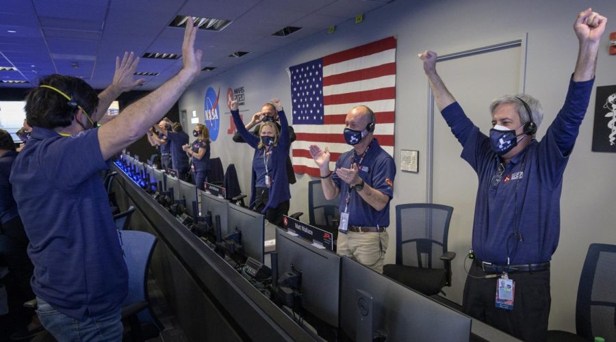 Members of NASA’s Perseverance rover team react in mission control after receiving confirmation the spacecraft successfully touched down on Mars, Thursday, Feb. 18, 2021, at NASA's Jet Propulsion Laboratory in Pasadena, California. A key objective for Perseverance’s mission on Mars is astrobiology, including the search for signs of ancient microbial life. The rover will characterize the planet’s geology and past climate, pave the way for human exploration of the Red Planet, and be the first mission to collect and cache Martian rock and regolith. Photo Credit: (NASA/Bill Ingalls)