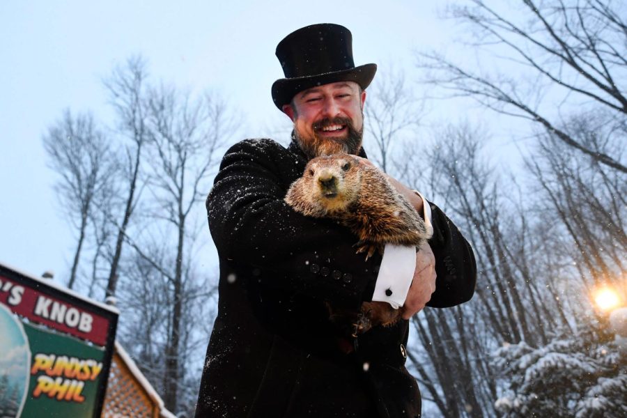 Groundhog Club handler A.J. Dereume holds Punxsutawney Phil, the weather prognosticating groundhog, during the 135th celebration of Groundhog Day on Gobbler's Knob in Punxsutawney, Pa. Tuesday, Feb. 2, 2021. Phil's handlers said that the groundhog has forecast six more weeks of winter weather during this year's event that was held without anyone in attendance due to potential COVID-19 risks. 