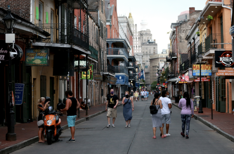 Pedestrians are seen walking along Bourbon Street in the French Quarter on July 14, 2020 in New Orleans, Louisiana. Louisiana Gov. John Bel Edwards issued three new restrictions for Phase II of reopening that will be in place until at least until July 24 across Louisiana to help prevent the spread of COVID-19.