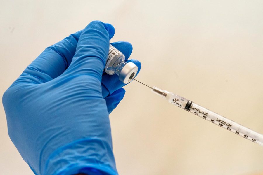 Registered Pharmacist Paula Agoglia fills a dead volume syringe with the COVID-19 vaccine at a pop-up vaccination site in the William Reid Apartments, Saturday, Jan. 23, 2021 in the Brooklyn borough of New York. The syringe allows for a full 6 doses to be extracted from each vial. (AP Photo/Mary Altaffer, Pool)