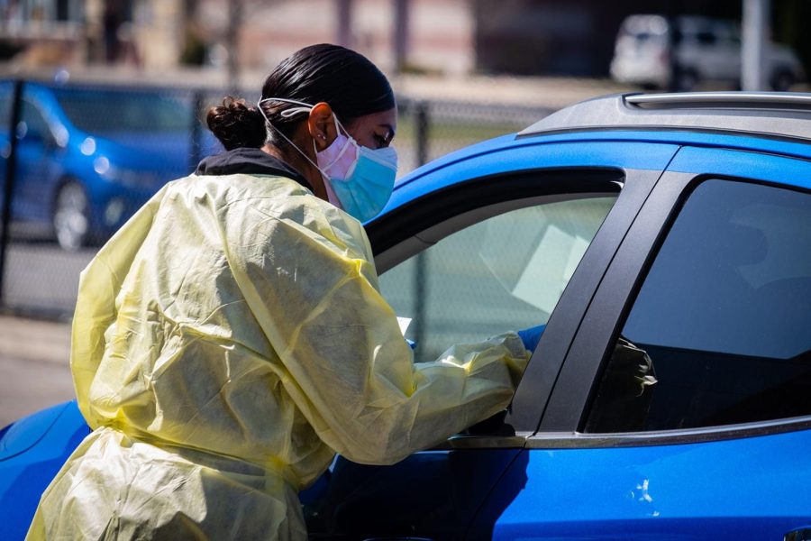 Medical Assistant Joann e Grajeda, a volunteer from El Paso, Tx., administers a COVID-19 antigen test at a testing clinic on Easter Sunday, April 4, 2021, at Memorial Stadium in Port Huron.