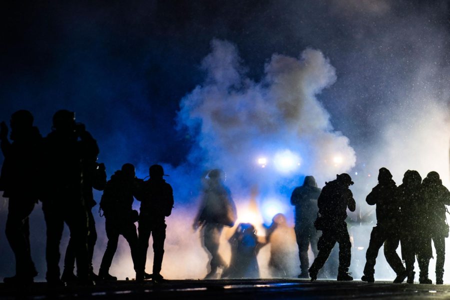 Authorities fire gas munitions at demonstrators gathered outside the Brooklyn Center Police Department to protest the shooting death of Daunte Wright, late Tuesday, April 13, 2021, in Brooklyn Center, Minn. (AP Photo/John Minchillo)