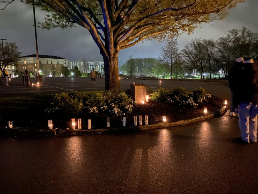 Community members lay their candles near the May 4 memorial overnight to honor those lost in the Kent State shootings 51 years ago. 