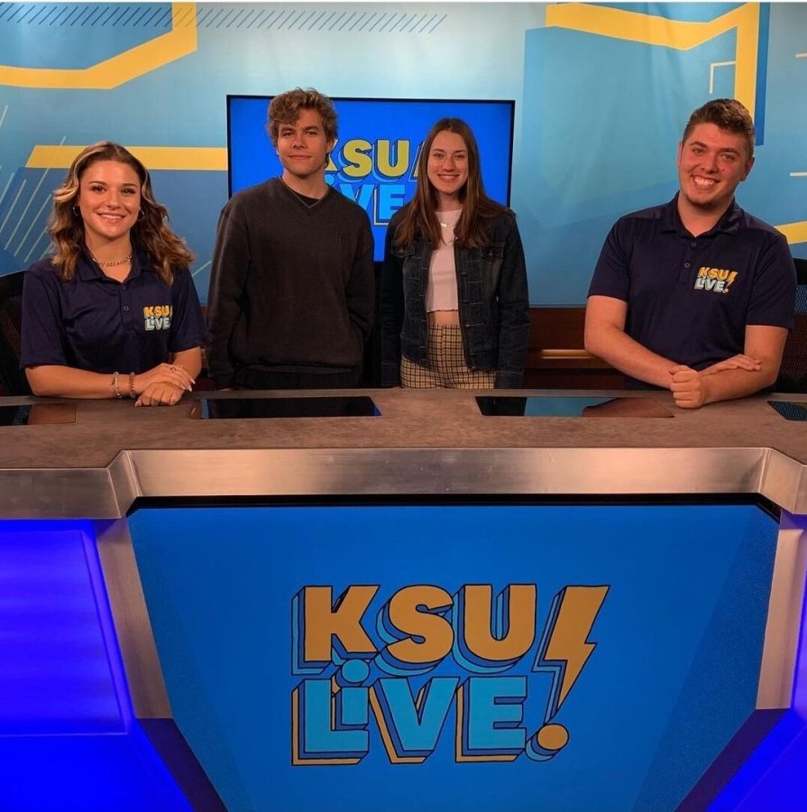 Producers Ben Pagani and Rachel Gross pose with anchors Jenna Gobrecht and Shane Troyano on the set of 'KSU Live!' in the Franklin Hall studio.