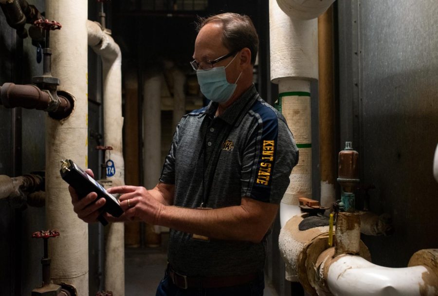 Robert Misbrener, project manager II from Kent State’s office of the university architect, gets ready to test the needlepoint bipolar ionization technology with the ion testing device. The university plans to buy additional devices so monthly maintenance checks can happen.