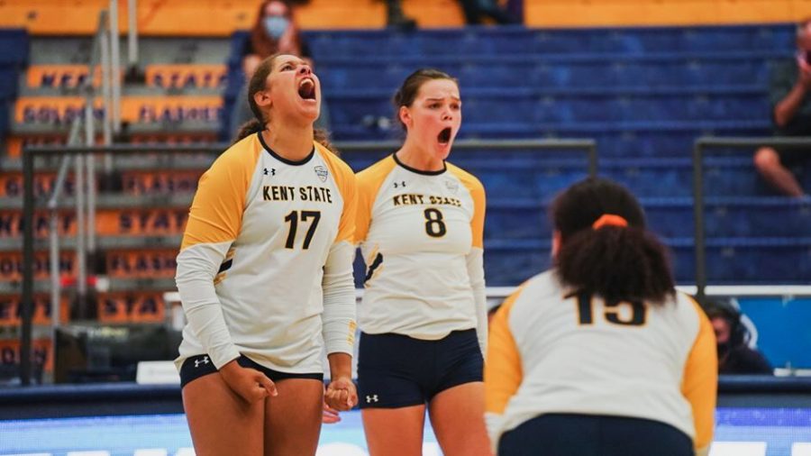 Danie Tyson (17) and Jacqlyn Caspers (8) celebrate during the Kent State volleyball team's celebrate win over Akron on Friday Oct. 15, 2021. 