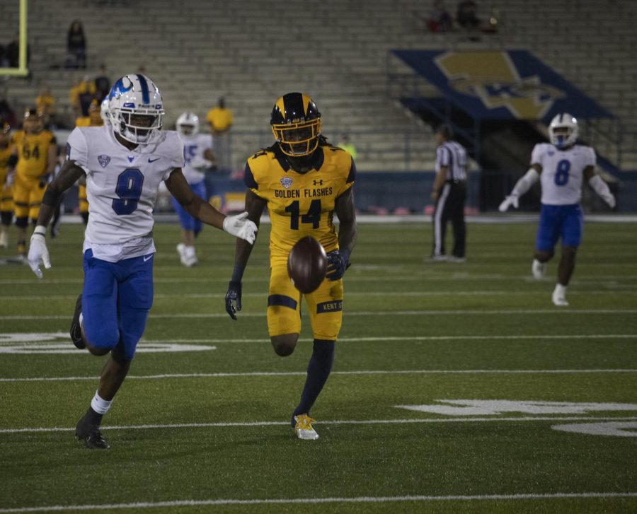 Wide receiver Dante Cephas (14) chases down the ball after quarterback Dustin Crum (7) throws it during the football game on Oct. 9, 2021. Kent State played University of Buffalo and beat them 48-38.