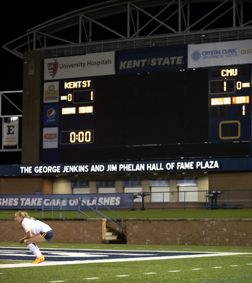 Redshirt senior Karly Hellstrom (23) kneels in front of the tied score board after the women's soccer game against Central Michigan University on Oct. 21, 2021. Kent State tied with Central Michigan University 1-1 in double overtime during their last home game of the regular season.