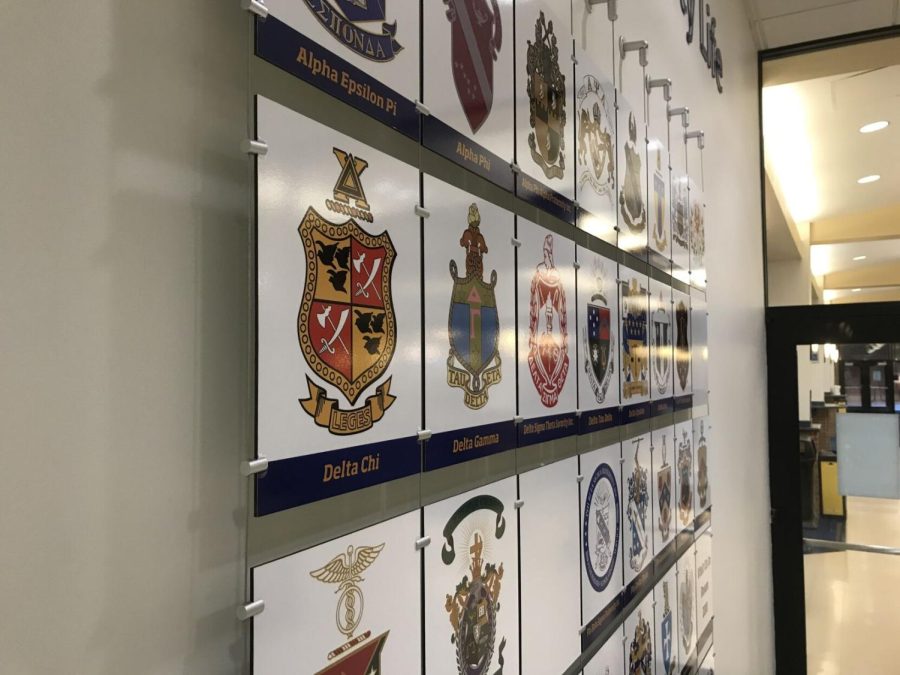 The crests of several Greek life organizations on a wall near the dining hall known as the Hub in the Kent Student Center. Ohio's Collin's Law, which went into effect Thursday, criminalizes hazing by any organizations, including on-campus Greek life.