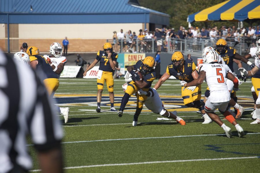 Sophomore Marquez Cooper, number 1, rushes through the Bowling Green State University's defensive during the football game on Oct. 2, 2021. Kent State won 27-20.