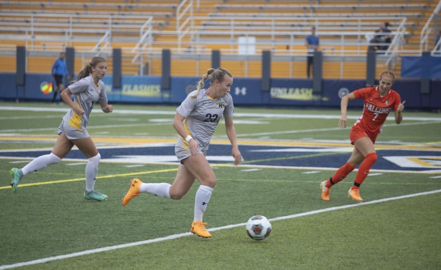 Redshirt senior defender Karly Hellstrom, number 23, dribbles the ball down the field during the women's soccer game against Bowling Green State University Oct. 3, 2021.