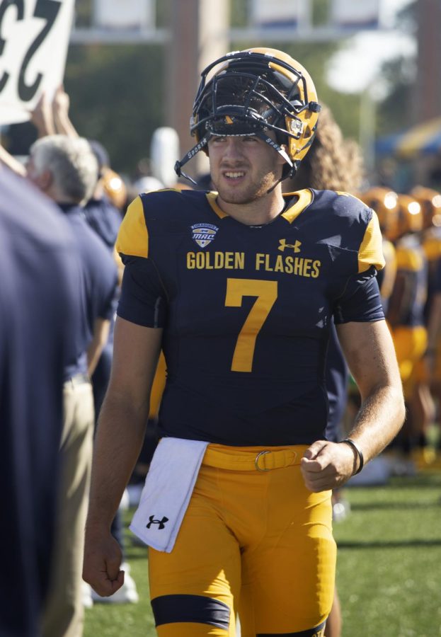 Grad Student Dustin Crum, number 7, walks on the side lines during the football game against Bowling Green State University on Oct. 2, 2021. Crum lead his team to victory with Kent State winning 27-20.