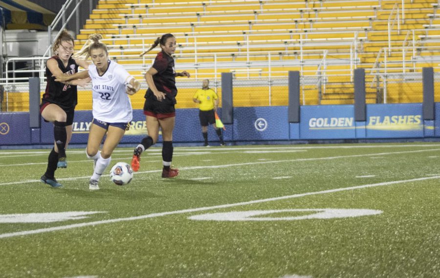 Redshirt senior forward Cameron Shedenhelm (22) kicks the ball away from NIU players at the women's soccer game on Oct. 7, 2021. Shedenhelm scored two goals at the Aug. 12 game vs. Youngstown State University.