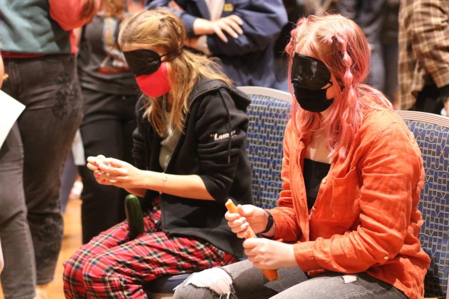 Junior history major Charissa Gilbert (left) and Cara Carson (right) put condoms on fruit as part of KSU’s Sextober Fest event.