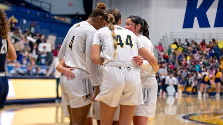 Members of the Kent State women's basketball team huddle up during a game. 