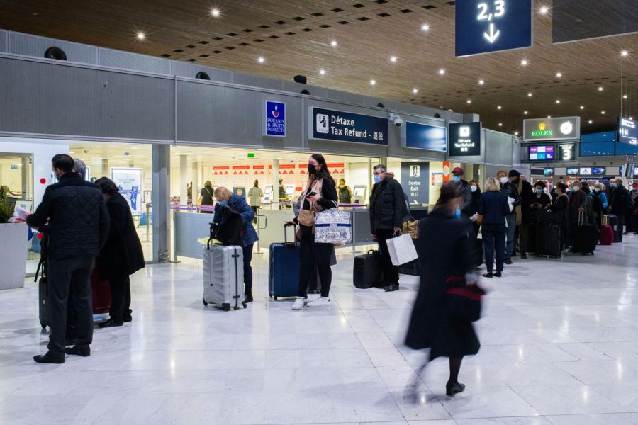 Airline passengers destined for the U.S., after the lifting of restrictions for vaccinated foreign travelers, wait for processing at Paris-Charles de Gaulle airport in Paris, France, on Monday, Nov. 8, 2021. The U.S. is lifting entry restrictions for more than 30 countries, allowing fully vaccinated travelers to fly from places including Europe, China and India. Photographer: Nathan Laine/Bloomberg via Getty Images