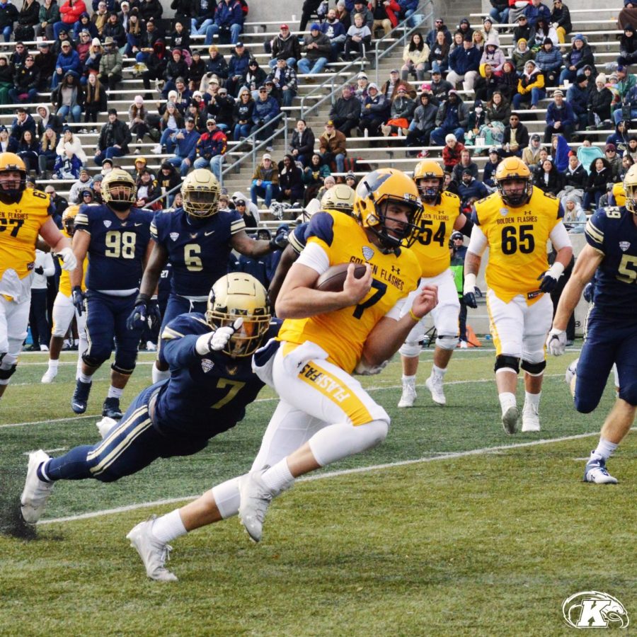 Graduate student quarterback Dustin Crum runs during the Kent State football team's win against Akron on Saturday, Nov. 20 in Akron, Ohio.