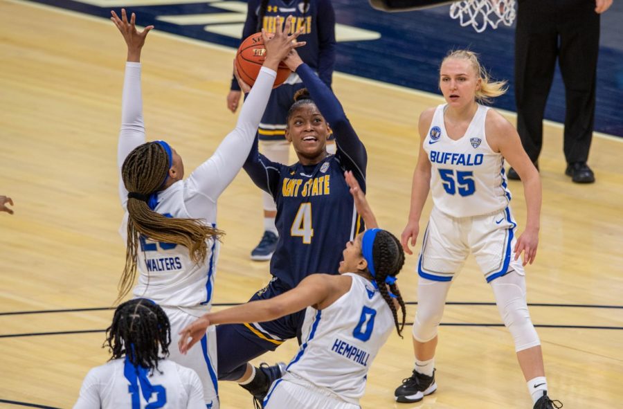 Sophomore Nila Blackford (4) fights through a sea of Buffalo defenders to get to the basket. Blackford would have a 12 point, 18 rebound double-double, but Kent State lost 73-66 and was eliminated from the MAC tournament. March 10, 2021.