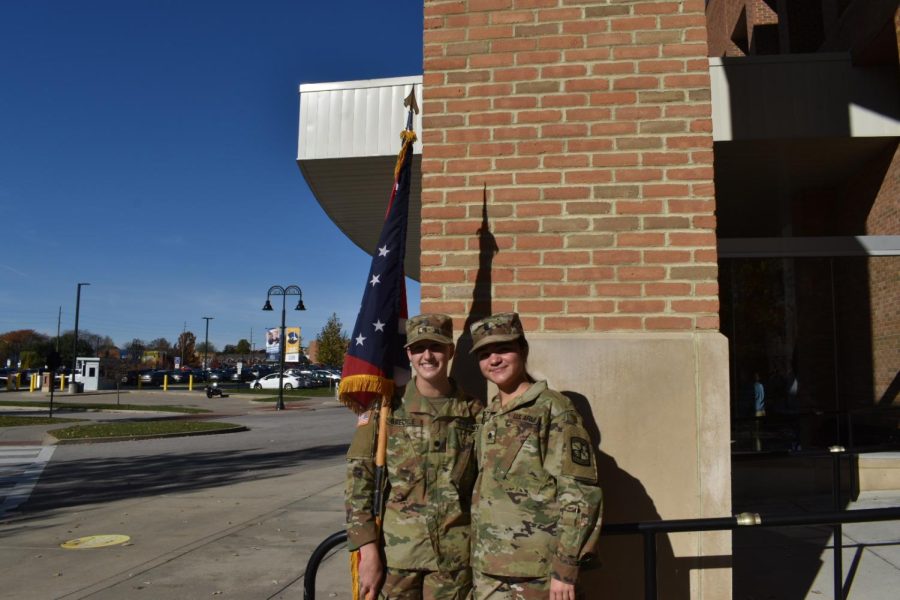 Kent State Army ROTC cadets Lily Baechle (left) and Karly McGee (right) with Ohio's state flag before the Veterans Day ceremony on Wed. Nov. 10, 2021.