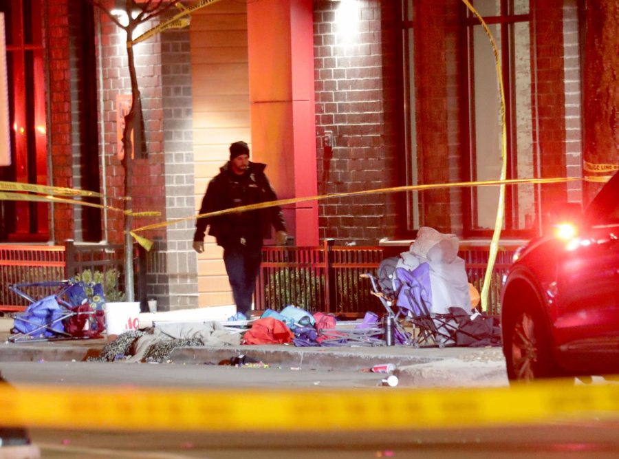 Police investigate at the scene of a crash involving multiple people and injuries at a holiday parade in Waukesha, Wis., on Sunday, Nov. 21, 2021. (Mike De Sisti/Milwaukee Journal-Sentinel via AP)