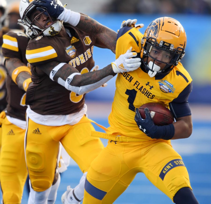 Kent State's Marquez Cooper pushes off against a Wisconsin defender during first half action at the Famous Idaho Potato Bowl in Boise, Idaho. Kent State lost the game 52-38. Photo by Bob Christy/Courtesy of Kent State University