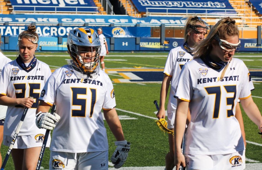 Members of Kent State's women's lacrosse team stand on the outlines of the field at DIX Stadium on Monday, March 22, 2021.