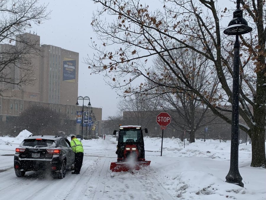 A Kent State operator stops plowing to talk to a driver as snow falls on campus from Winter Storm Landon on Thursday, Feb. 3, 2022. 