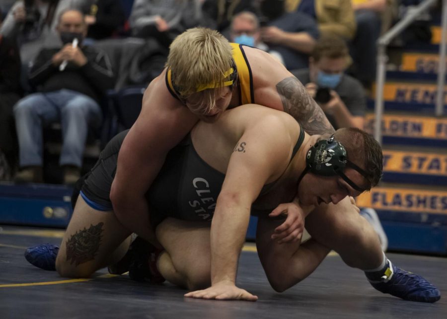 Redshirt junior Jacob Cover attempts to pin a Cleveland State University wrestler during the wrestling meet on Jan. 27, 2022. Cover scored a 3 points against his opponent which lead Kent to beat Cleveland State 27-9.