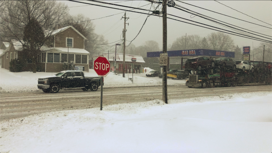 Vehicles travel down South Water Street amid snowfall from winter storm Landon on Thursday, Feb. 3, 2022. 