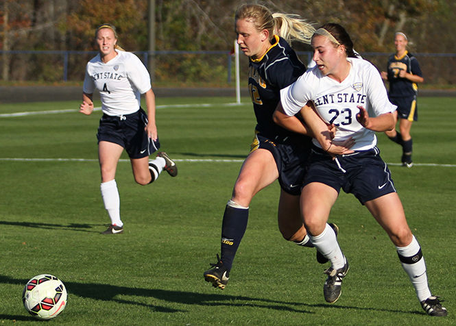 Kent State's Jenna Hellstrom gets tangled up with Toledo's Gabby Epelman while chasing after the ball during a game Friday, Oct. 24, 2014. The Flashes won 3-0.