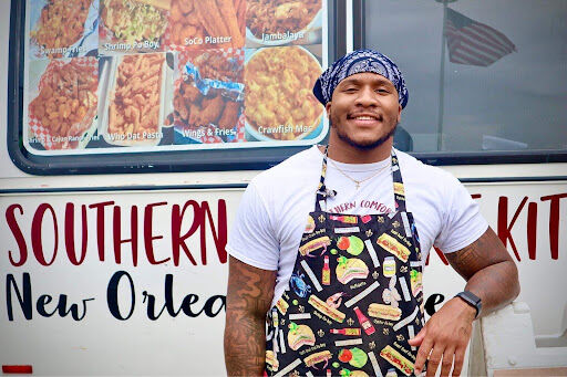 Will Matthews stands outside of the Southern Comfort Food Truck. The 2019 Kent graduate wanted to bring food to Kent's campus that reflected the food he ate back home. 