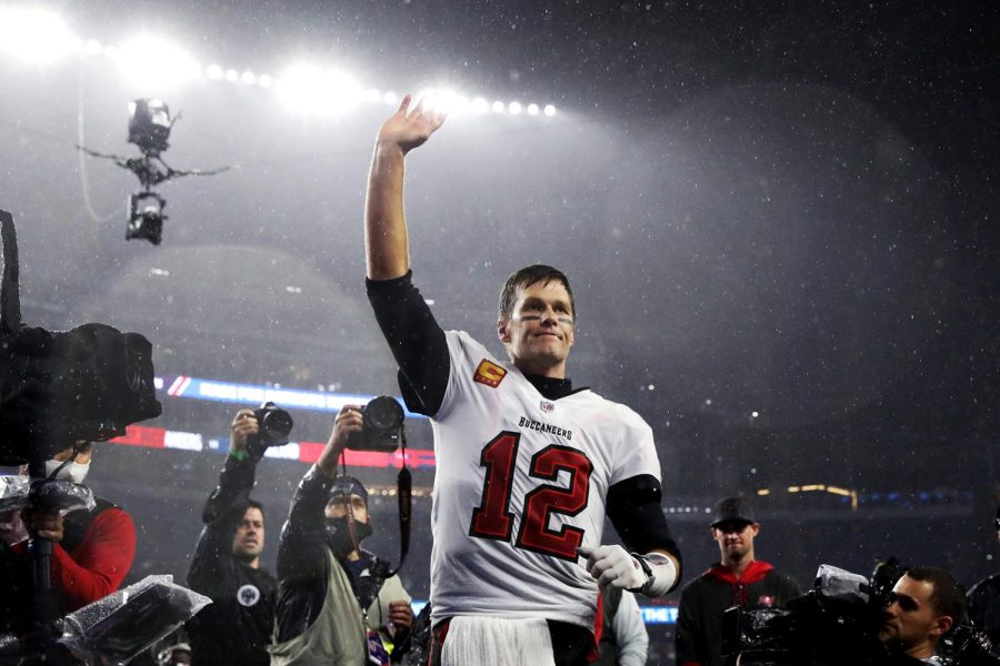 FOXBOROUGH, MASSACHUSETTS - OCTOBER 03: Tom Brady #12 of the Tampa Bay Buccaneers waves to the crowd as he runs off the field after defeating the New England Patriots in the game at Gillette Stadium on October 03, 2021 in Foxborough, Massachusetts. (Photo by Maddie Meyer/Getty Images)