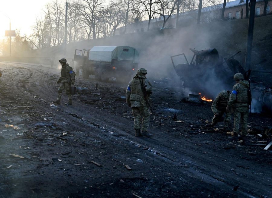 Ukrainian service members collect unexploded shells after a fighting with Russian raiding group in the Ukrainian capital of Kyiv in the morning of February 26, 2022, according to Ukrainian service personnel at the scene. - Ukrainian soldiers repulsed a Russian attack in the capital, the military said on February 26 after a defiant President Volodymyr Zelensky vowed his pro-Western country would not be bowed by Moscow. It started the third day since Russian leader Vladimir Putin unleashed a full-scale invasion that has killed dozens of people, forced more than 50,000 to flee Ukraine in just 48 hours and sparked fears of a wider conflict in Europe. (Photo by Sergei SUPINSKY / AFP) (Photo by SERGEI SUPINSKY/AFP via Getty Images)