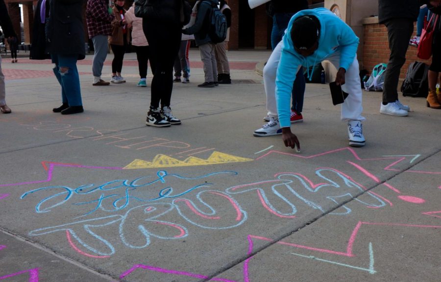 The students at the protest against house bill 327 drew messages to the other students with chalk on the "K" after the protest today on Wednesday, March 9. This student, AJ, wrote "teach the truth" in bright colors.