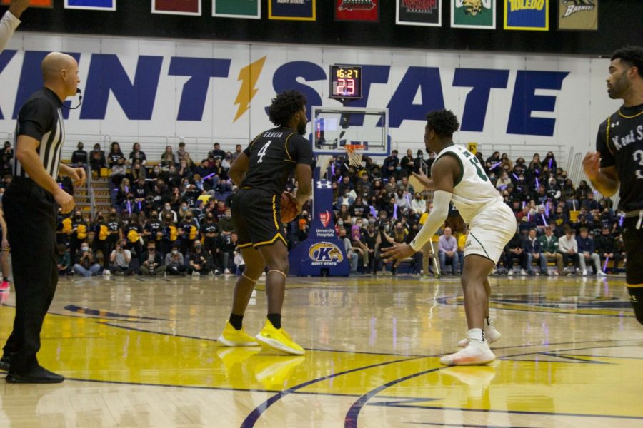 Golden Flashes men's basketball play Ohio University's Bobcats and win 75 to 52 on Friday, Feb. 18, 2022. Graduate student point guard Andrew Garcia (on left) in possession of the ball.