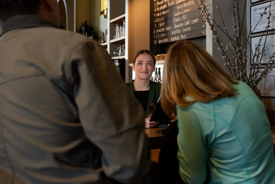 Server Emily Beedlow takes 
a customer's order at Bell Tower Brewing Co.