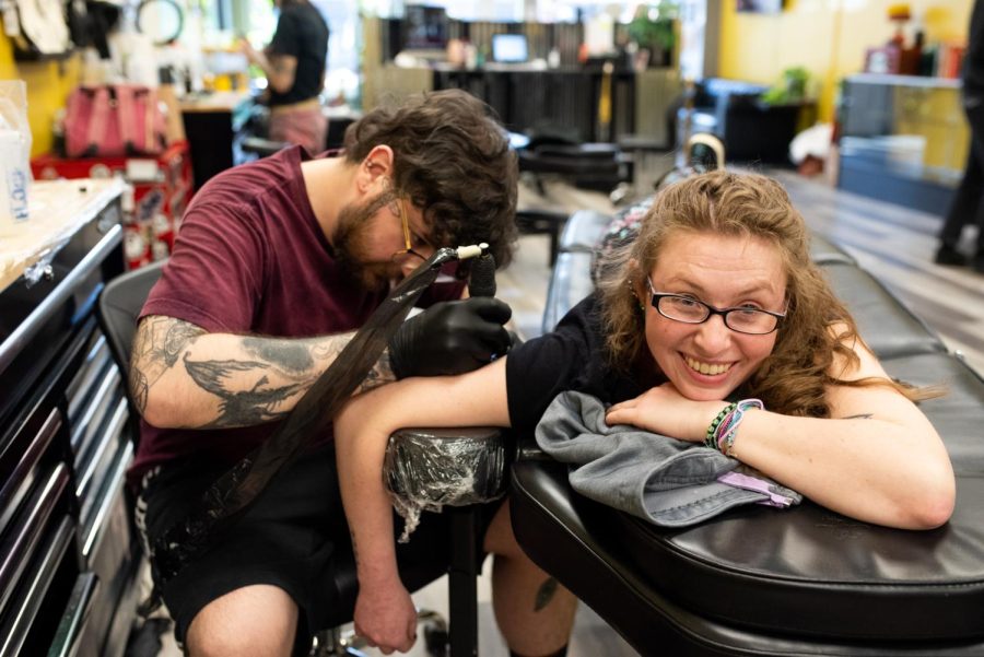 Artist Nick Osborne inks Kenzie Faust at Black Sheep Tattoo Studios in downtown Ravenna.