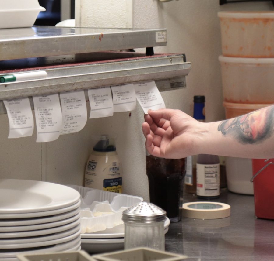 A chef at Belleria takes orders during a dinner rush. 