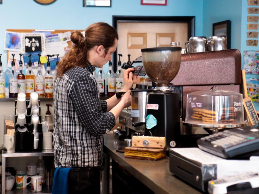 The barista at Last Exit makes an espresso shot for a customer's coffee drink.