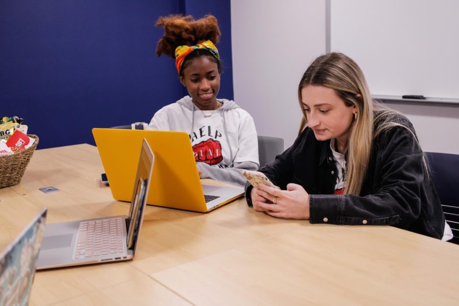 Tamra McMillion and Maggie Werren, members of the Gold Team run the necessary preparations for the Kahoot game for the national B.E.A.T Lymphoma Campaign. 
