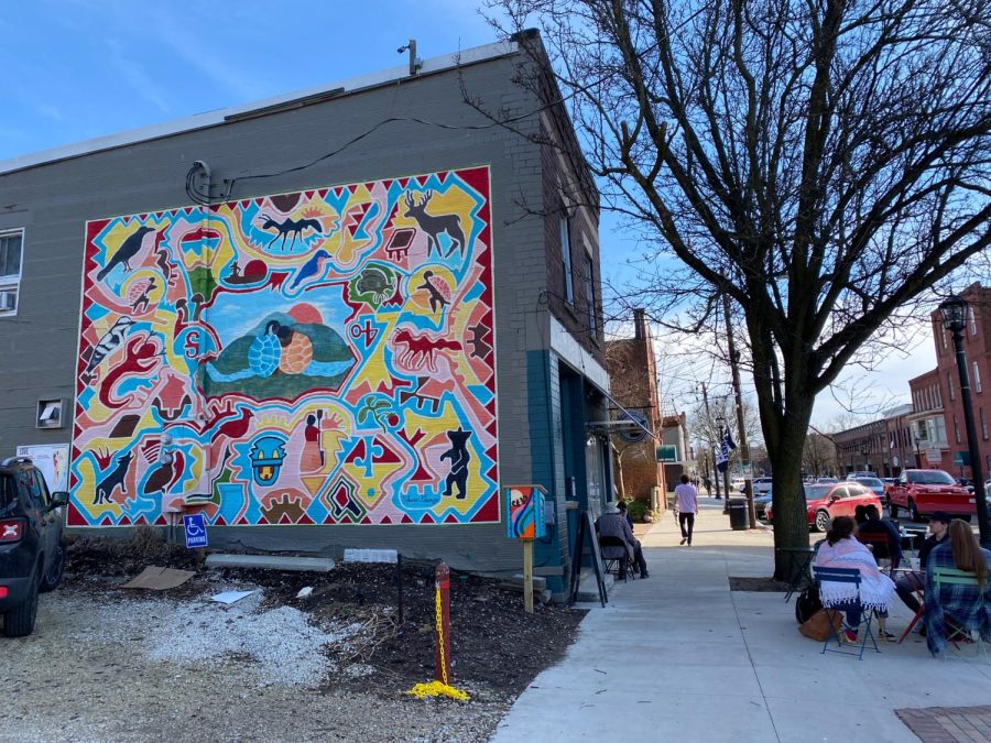 Scribbles Coffee Co. has outside seating when it is nice out and a mural on the side of the building.