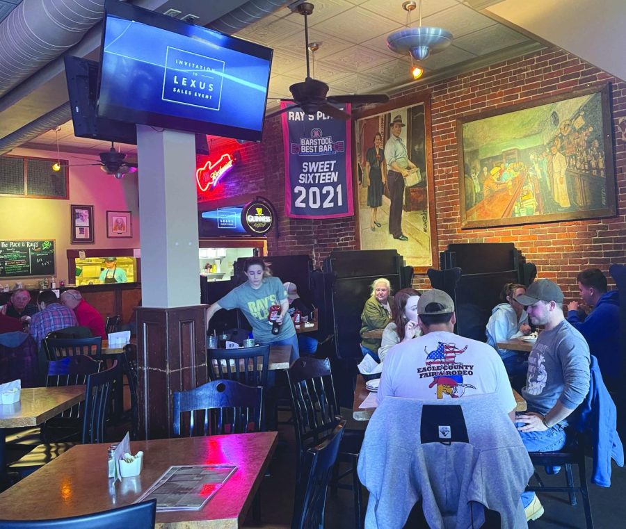 A waitress clears a table on a busy day at Ray's.